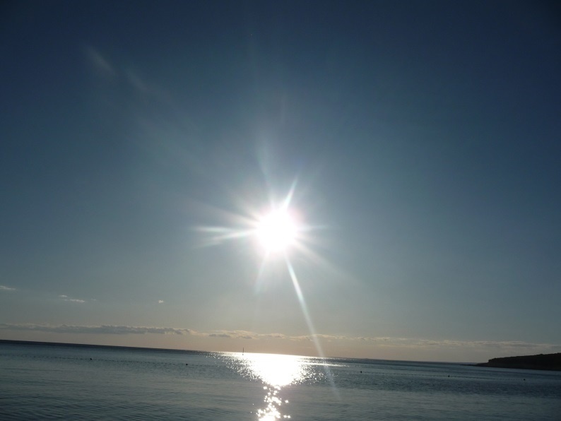 The sun is low over the sea