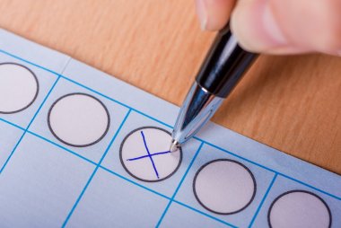 a blue cross on a ballot paper
