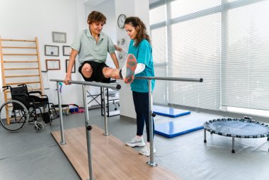 Cover picture Health, rehabilitation & care services Young man uses parallel bars in a rehab center